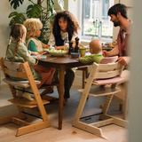 A Vanilla White and Natural Tripp Trapp in use in a family setting