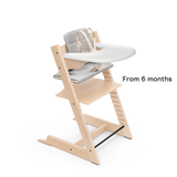 Natural Tripp Trapp chair with, an Anthracite Tripp Trapp cushion, the natural Babyset and a Stokke White Tray