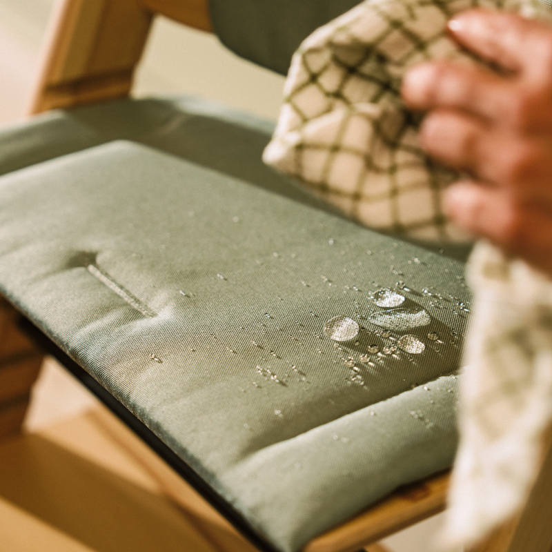 Glacier Green cushion for the Tripp Trapp chair, showing it's ease of cleaning fabric